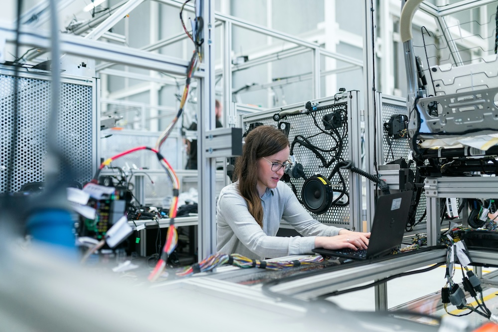 AI-powered manufacturing control room with multiple monitors showing real-time data